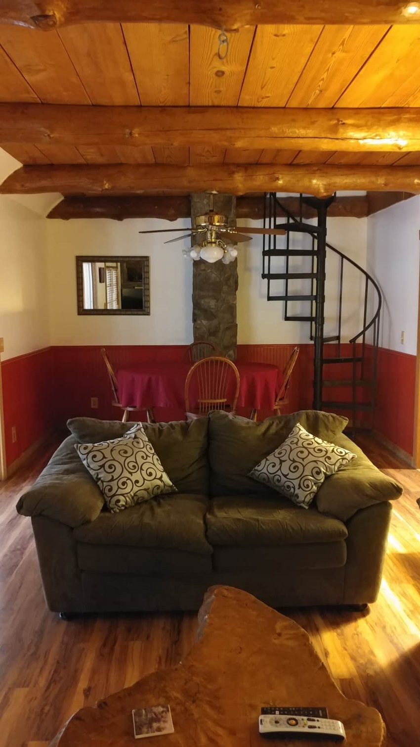 Living Area With Comfortable Sofa And Spiral Staircase